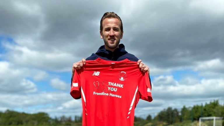 Harry Kane holding the new Leyton Orient shirt, which he has sponsored with the names of charities
