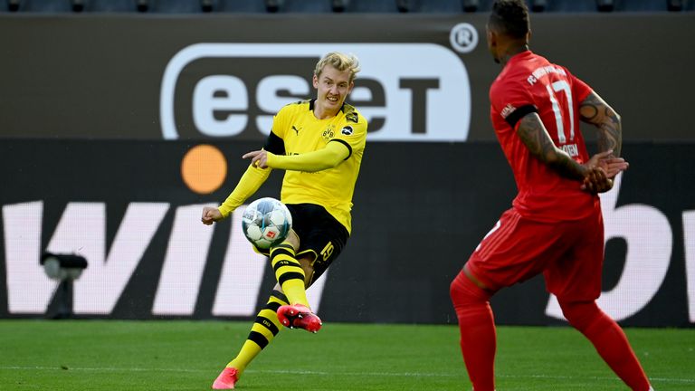 Bayern Munich's defender Jerome Boateng (R) reacts as Dortmund's Julian Brandt has a shot