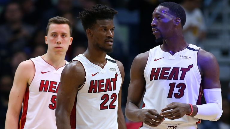 Jimmy Butler of the Miami Heat, Bam Adebayo and Duncan Robinson react against the New Orleans Pelicans