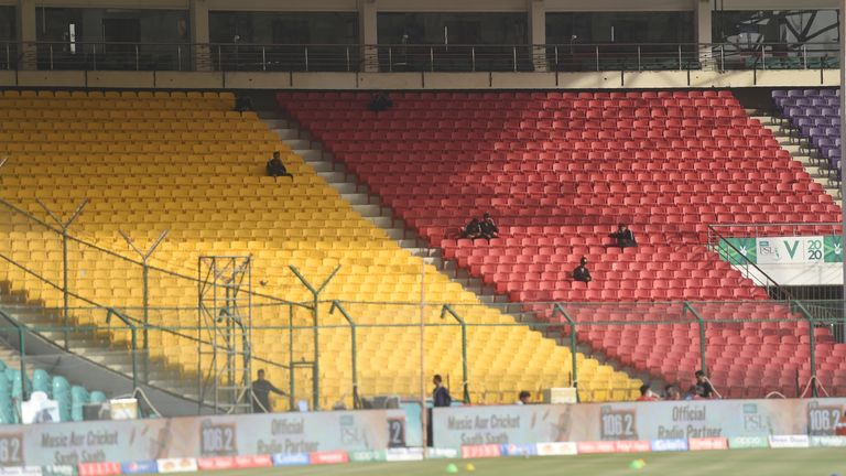 Pakistani paramilitary soldiers sit in empty spectators enclosures amid concerns over the spread of the COVID-19 novel coronavirus, during the T20 cricket match between Karachi Kings and Islamabad United at the National Cricket Stadium in Karachi on March 14, 2020.  (Photo by Asif HASSAN / AFP) (Photo by ASIF HASSAN/AFP via Getty Images)