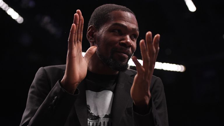 Kevin Durant applauds his Brooklyn team-mates from the sideline