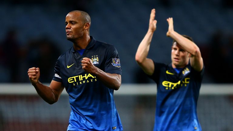 Vincent Kompany and James Milner during the Barclays Premier League match between Aston Villa and Manchester City at Villa Park on October 4, 2014 in Birmingham, England.