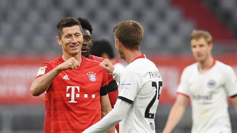 Robert Lewandowski of FC Bayern Munich interacts with Erik Durm of Eintracht Frankfurt after the Bundesliga match between FC Bayern Muenchen and Eintracht Frankfurt at Allianz Arena on May 23, 2020 in Munich, Germany.