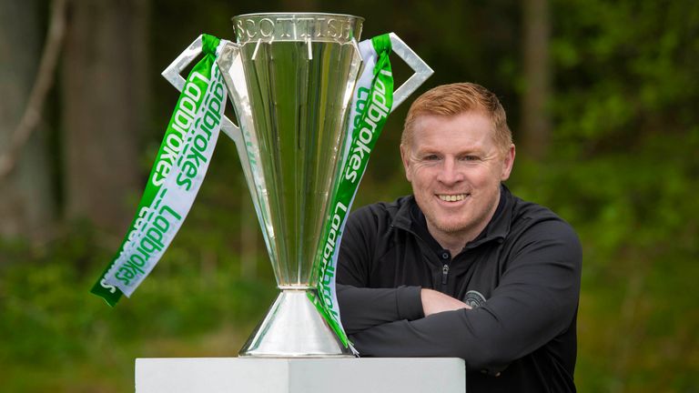 Neil Lennon poses alongside the Ladbrokes Premiership trophy after Celtic are confirmed as champions