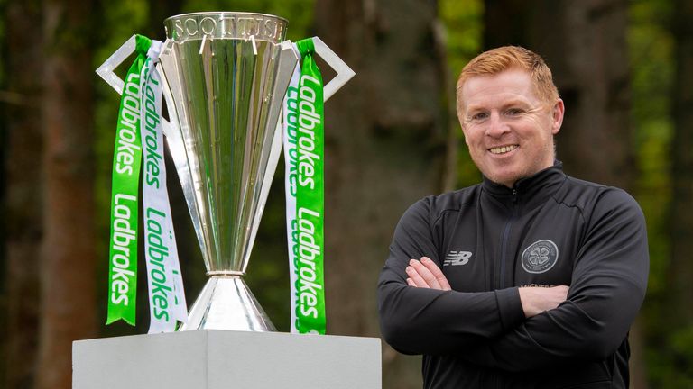 Neil Lennon poses alongside the Ladbrokes Premiership trophy after Celtic are confirmed as champions