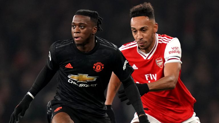 Manchester United&#39;s Aaron Wan-Bissaka (left) and Arsenal&#39;s Pierre-Emerick Aubameyang battle for the ball during the Premier League match at the Emirates Stadium, London. 