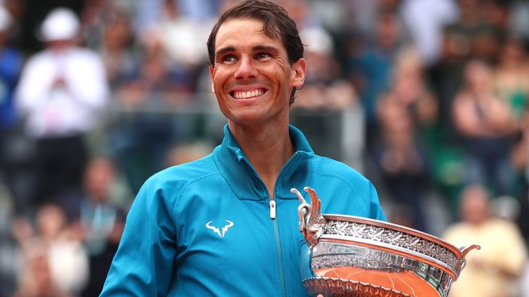 Rafael Nadal of Spain hugs the Musketeers' Cup as he celebrates victory following the mens singles final against Dominic Thiem of Austria during day fifteen of the 2018 French Open at Roland Garros on June 10, 2018 in Paris, France