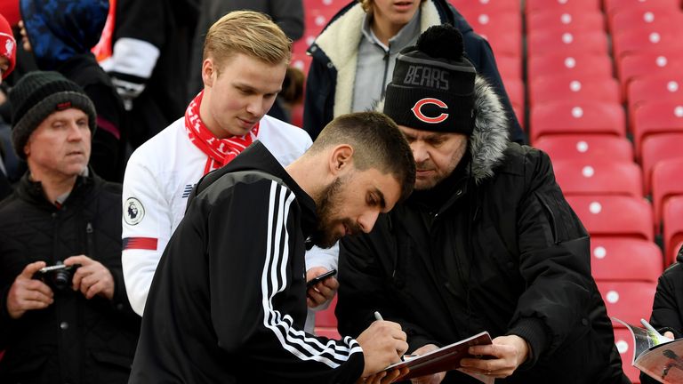 The Portuguese signs autographs for supporters at Anfield this season