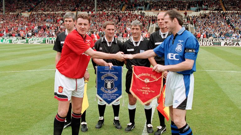 Manchester United captain Steve Bruce greets Watson at the coin toss