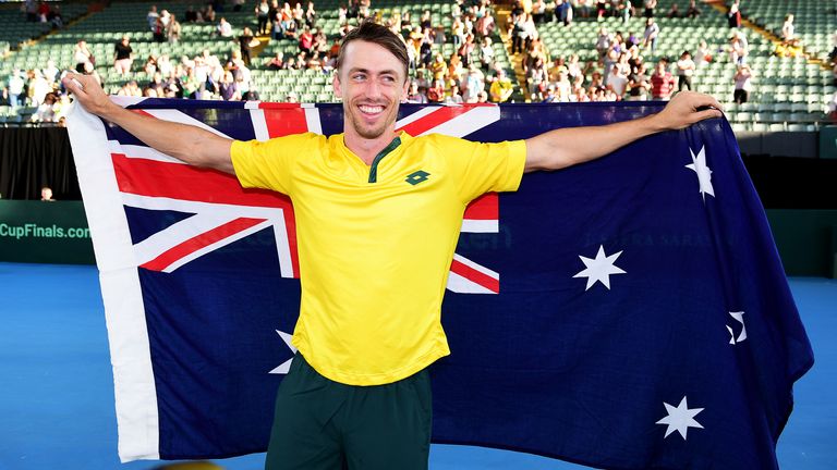 John Millman of Australia celebrates with the Australian flag after the Davis Cup Qualifier singles match between John Millman of Australia and Thiago Monteiro of Brazil at Memorial Drive on March 07, 2020 in Adelaide, Australia. 