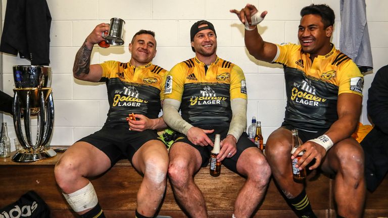 TJ Perenara, Cory Jane and Julian Savea of the Hurricanes celebrate in the changing room after the Hurricanes won the 2016 Super Rugby Final match between the Hurricanes and the Lions at Westpac Stadium on August 6, 2016 in Wellington, New Zealand.
