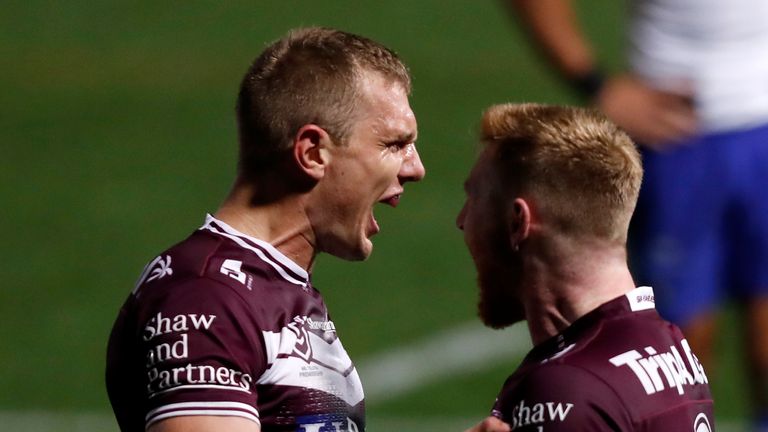 Tom Trbojevic (L) of the Sea Eagles celebrates with try-scorer Brad Parker of the Sea Eagle