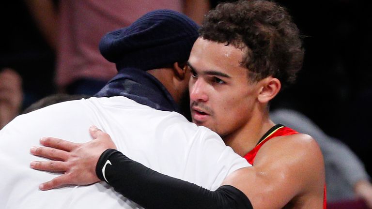 Trae Young shares a hug with Kobe Bryant at an Atlanta Hawks-Brooklyn Nets game