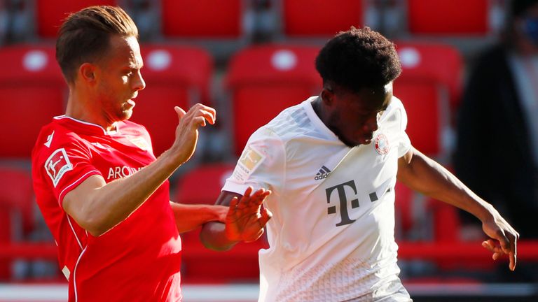 FC Union Berlin's Marcus Ingvartsen in action with Bayern Munich's Alphonso Davies