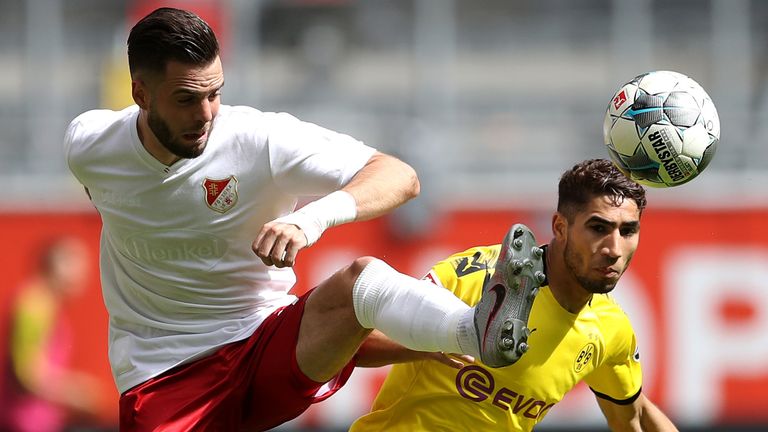 Niko Giesselmann of Fortuna Dusseldorf battles for the ball with Achraf Hakimi of Borussia Dortmund