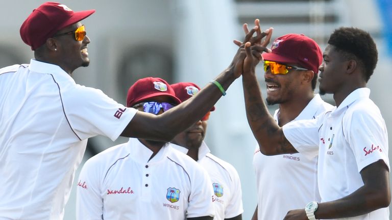 Jason Holder celebrates with Joseph on day three of the Antigua Test against England