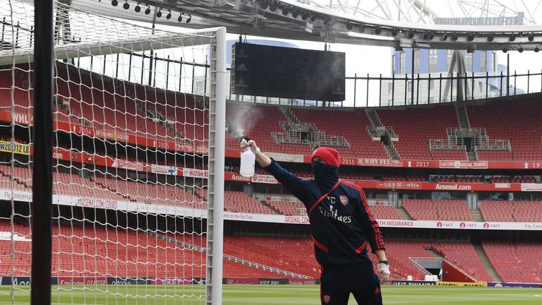 Arsenal groundstaff clean the goalpoasts before a friendly match between Arsenal and Charlton Athletic at Emirates Stadium on June 06, 2020 in London, England. (Photo by Stuart MacFarlane/Arsenal FC via Getty Images)
