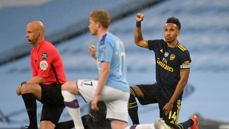 Pierre-Emerick Aubameyang of Arsenal takes a knee in support of the Black Lives Matter movement prior to the Premier League match between Manchester City and Arsenal FC at Etihad Stadium on June 17, 2020 in Manchester, United Kingdom.