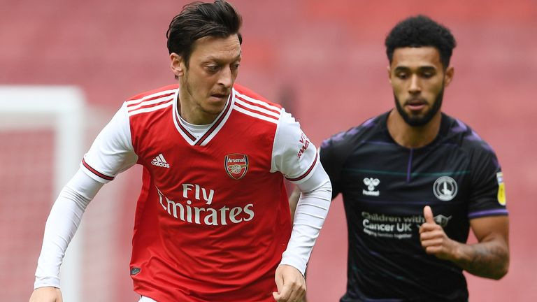  Mesut Ozil of Arsenal breaks past Andre Green of Charlton during a friendly match between Arsenal and Charlton Athletic at Emirates Stadium on June 06, 2020 in London, England. (Photo by Stuart MacFarlane/Arsenal FC via Getty Images)
