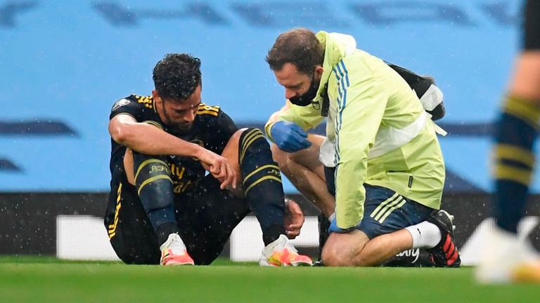 Arsenal defender Pablo Mari receives treatment after being injured against Manchester City
