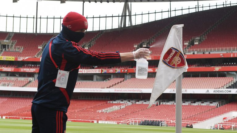 Arsenal groundstaff cleans the corner flag before a friendly match between Arsenal and Charlton Athletic at Emirates Stadium on June 06, 2020 in London, England. (Photo by Stuart MacFarlane/Arsenal FC via Getty Images)