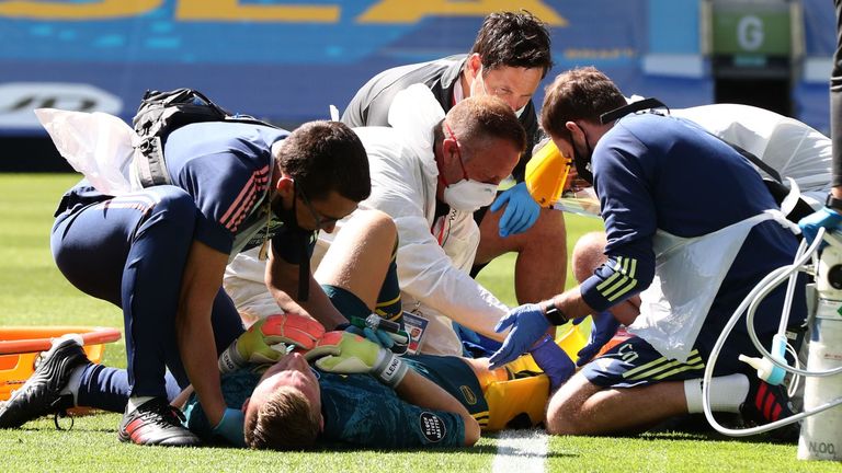 Bernd Leno receives treatment after falling awkwardly at Brighton