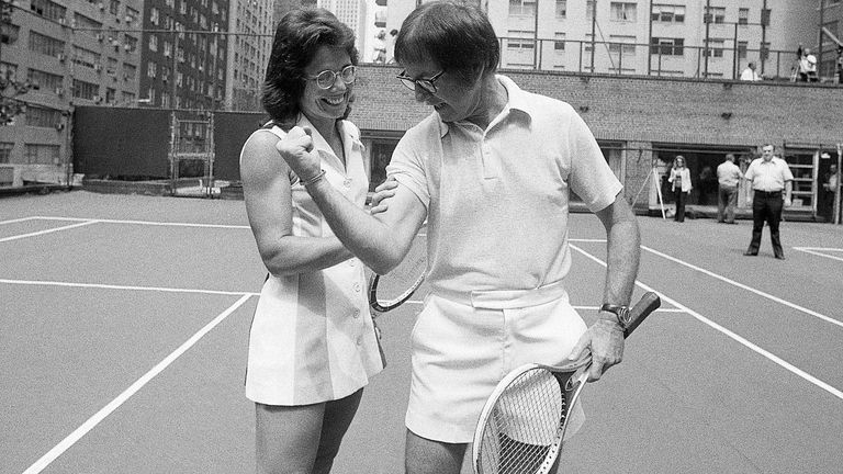 Bobby Riggs flexes his biceps in an attempt to intimidate Billie Jean King. The two played against each other September 20, 1973. King won the match in straight sets.