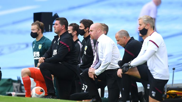 Burnley manager Sean Dyche and his backroom staff take a knee