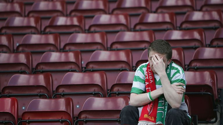 MOTHERWELL, UNITED KINGDOM - MAY 22:  A Celtic fan holds his head in his hands after Celtic lost 2-1 to Motherwell resulting in their rivals Glasgow Rangers lifting the league title after the Scottish Premier League match between Motherwell and Celtic at Fir Park on May 22, 2005, Motherwell, Scotland.  (Photo by Christopher Furlong/Getty Images)