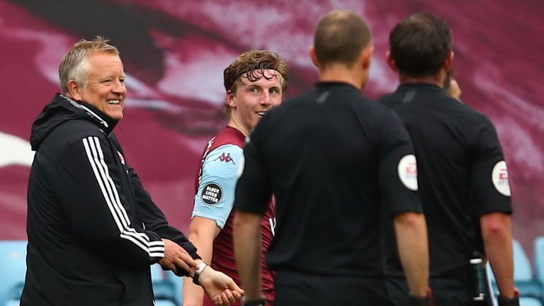 Chris Wilder speaks to referee Michael Oliver after Sheffield United's 0-0 draw with Aston Villa