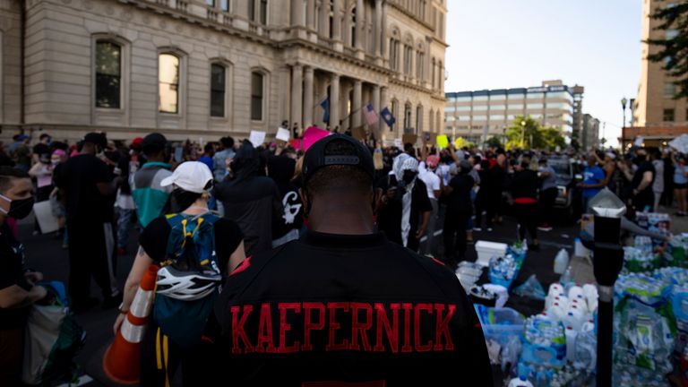 A protester wears a Colin Kaepernick jersey outside city hall in Louisville, Kentucky in May 2020