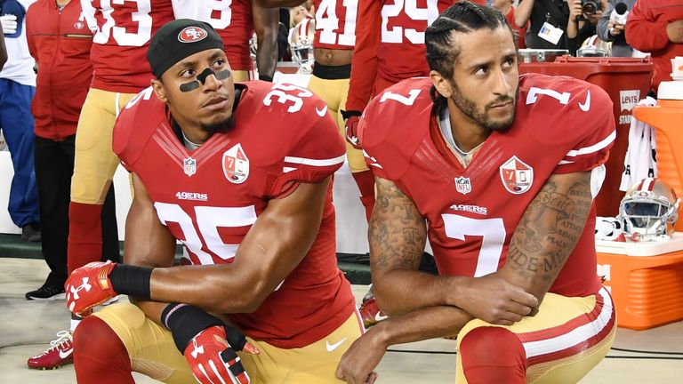 Colin Kaepernick and Eric Reid kneeling in protest against police brutality and racial oppression in 2016