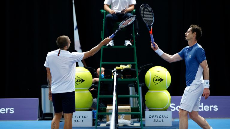 Dan Evans and Andy Murray greet at the net 