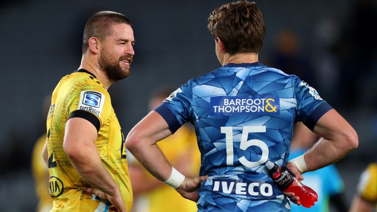 Dane Coles (L) and Beauden Barrett catch up after the game