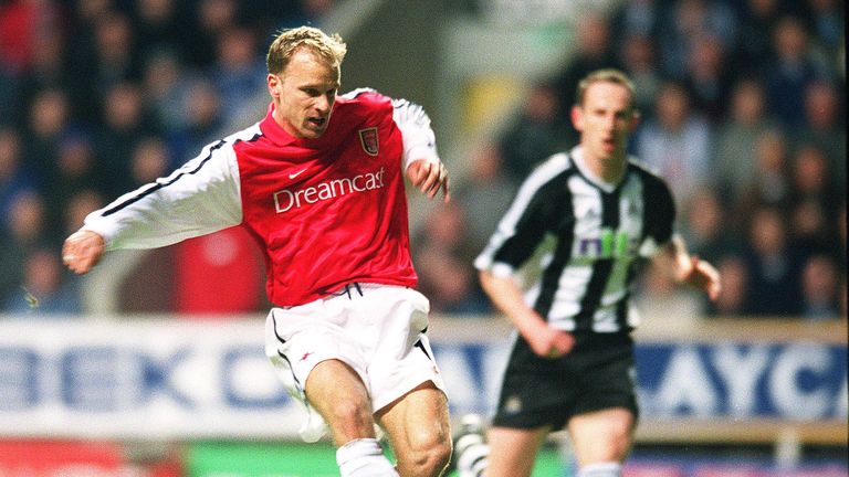 Bergkamp shoots past goalkeeper Shay Given to score in Arsenal's win