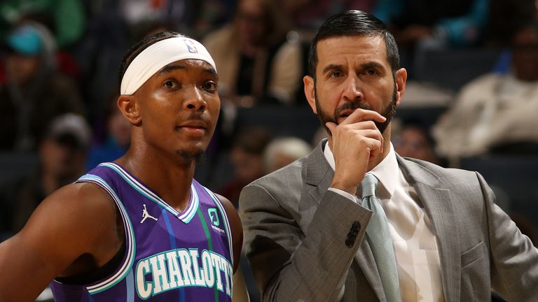 DeVonte' Graham and head coach James Borrego talk share their thoughts during a Hornets game