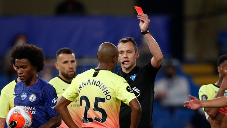 Fernandinho of Manchester City is shown a red card by Stuart Attwell 