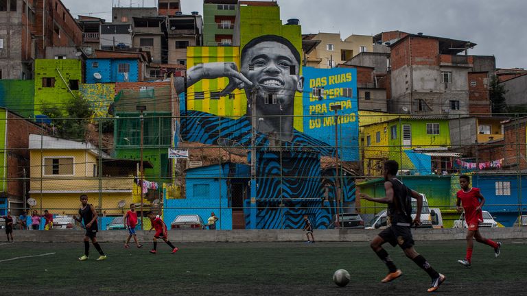 SAO PAULO, BRAZIL - JUNE 12: Children play soccer in front of the graffiti mural of the striker of the Brazilian soccer team Gabriel Jesus. The painting was done by a group of artists to pay homage to the attacker who grew up in the area, the Jardim Peri neighborhood that is one of the poorest neighborhoods in the city of S..o Paulo on June 12, 2018 in Sao Paulo, Brazil. (Photo by Victor Moriyama/Getty Images)