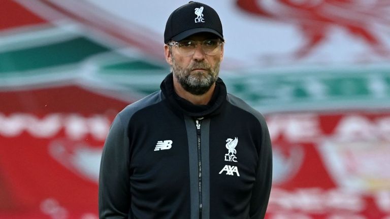 Liverpool's German manager Jurgen Klopp watches his players warm up ahead of the English Premier League football match between Liverpool and Crystal Palace at Anfield in Liverpool, north west England on June 24, 2020. 