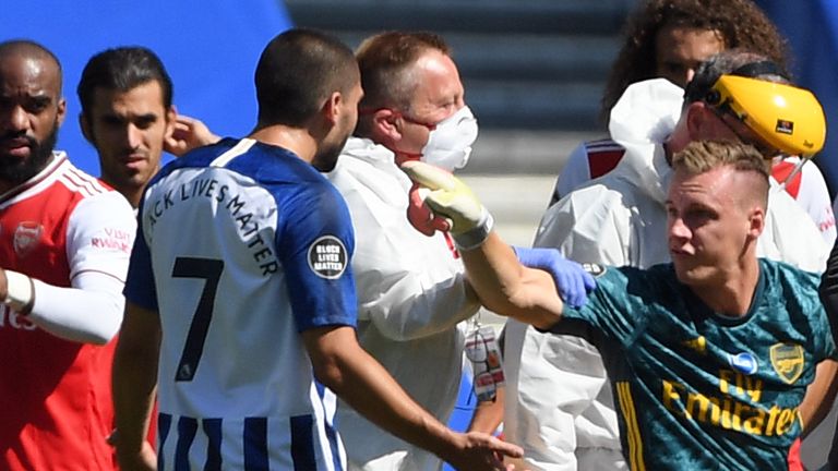 Bernd Leno points the finger at Neal Maupay after suffering an injury