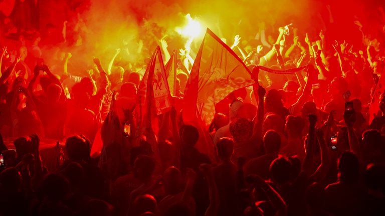 Liverpool fans celebrate at Anfield after they were crowned Premier League champions