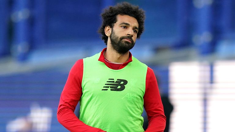 Mo Salah warms up on the sidelines during the Merseyside derby