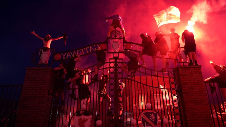 Euphoric fans climbed the gates around Anfield 