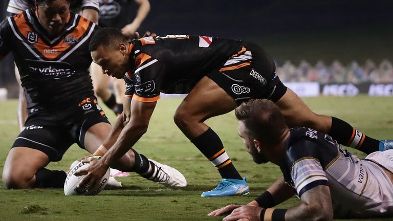 SYDNEY, AUSTRALIA - JUNE 20: Moses Mbye of the Tigers scores a try during the round six NRL match between the Wests Tigers and the North Queensland Cowboys at Campbelltown Stadium on June 20, 2020 in Sydney, Australia. (Photo by Mark Metcalfe/Getty Images)