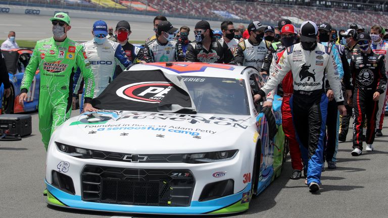 NASCAR drivers push the No 43 Victory Junction Chevrolet, driven by Bubba Wallace, to the front of the grid as a sign of solidarity with the driver prior to the NASCAR Cup Series GEICO 500 at Talladega Superspeedway in Talladega, Alabama