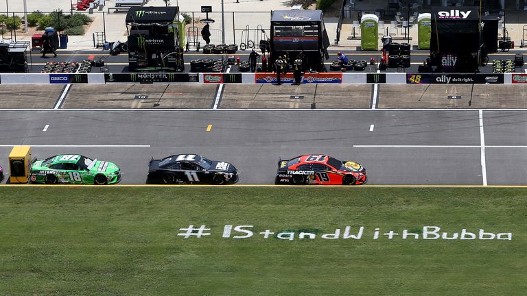 An #IStandWithBubba message has appeared on the grass before a NASCAR race at Talladega Superspeedway in Lincoln, Alabama
