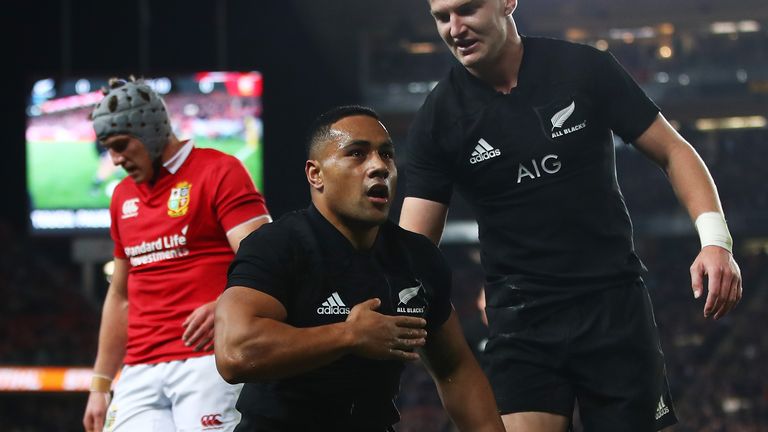 Ngani Laumape  celebrates scoring with a disappointed Jonathan Davies in the background