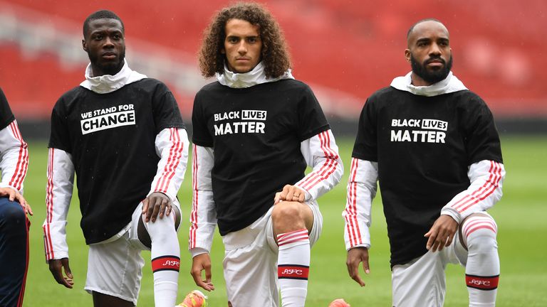 Nicolas Pepe, Matteo Guendouzi and Alexandre Lacazette of Arsenal take a knee in support of Black Lives Matter before the friendly match against Brentford