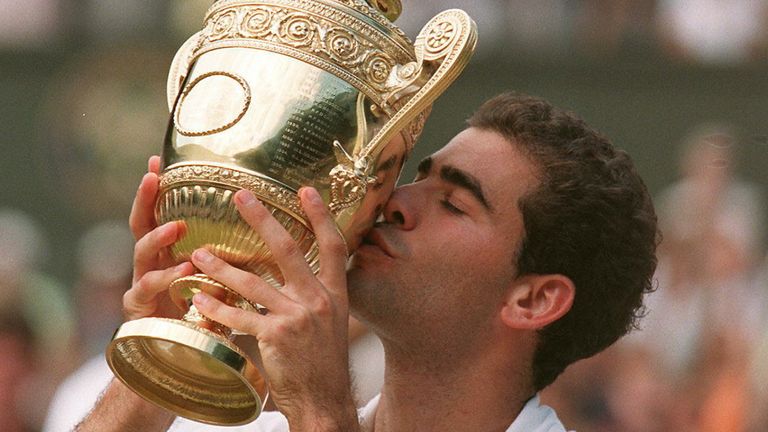 Pete Sampras kisses the cup after winning the men's singles final at the Wimbledon Championships 06 July against French Cedric Pioline 