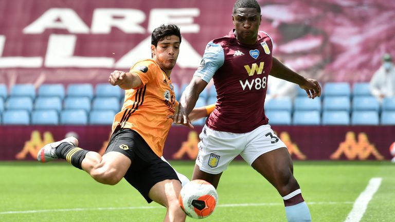 Raul Jimenez takes a shot as Kortney Hause challenges the Wolves striker